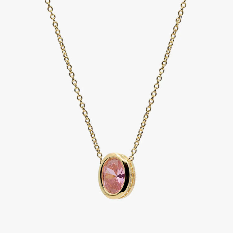 A delicate gold chain necklace with an oval pendant featuring a pink faceted gemstone in a gold bezel setting, shown against a plain light gray background.