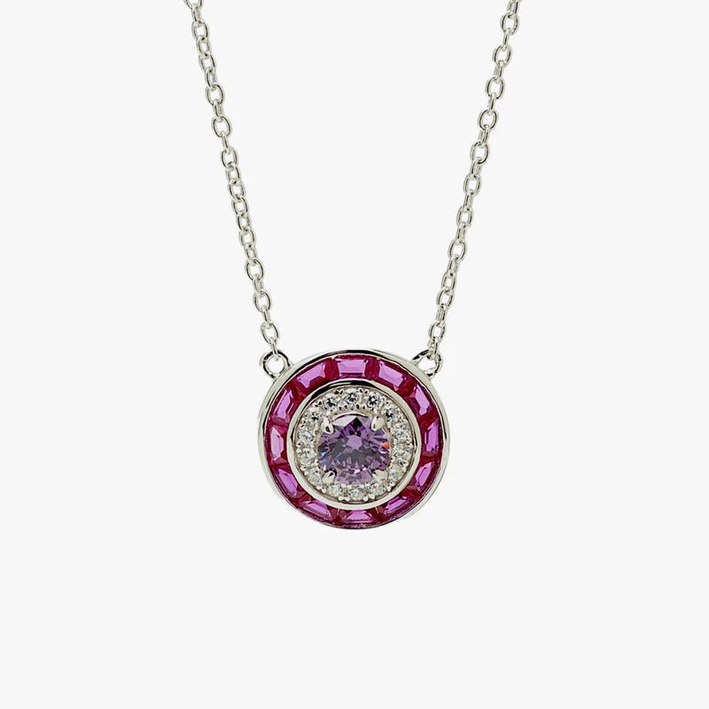 A silver-toned oval pendant necklace featuring a central light purple gemstone surrounded by a halo of small clear stones and an outer ring of deep pink stones, shown on a plain light gray background.