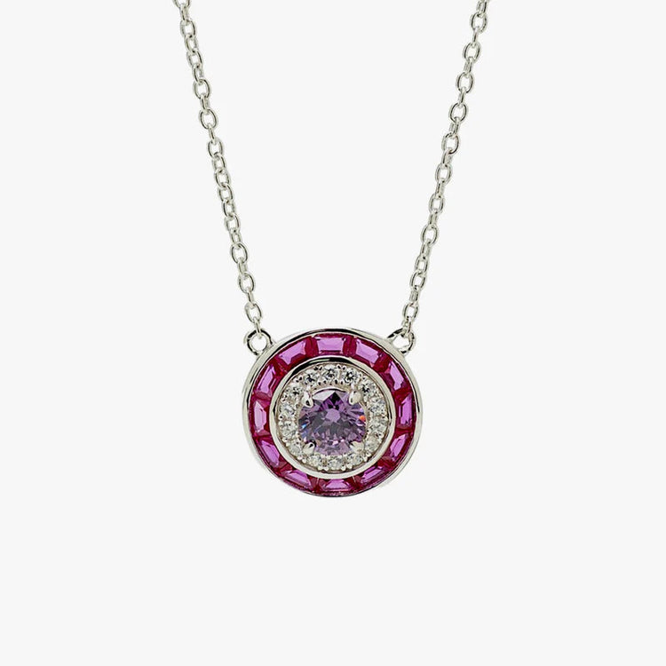 A silver-toned oval pendant necklace featuring a central light purple gemstone surrounded by a halo of small clear stones and an outer ring of deep pink stones, shown on a plain light gray background.