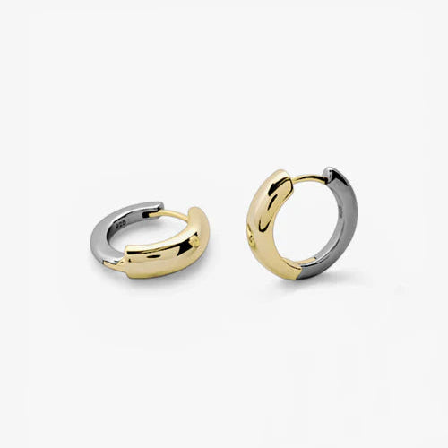 A pair of small huggie hoop earrings in a two-tone yellow gold and silver finish, displayed on a clean white background.