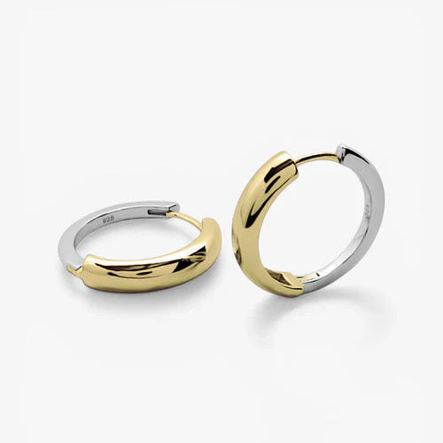 Two polished two-tone hoop earrings, one in yellow gold and one in silver, displayed on a clean white background.
