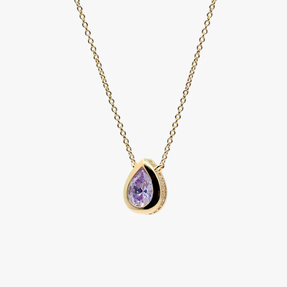 A gold teardrop pendant necklace featuring a purple teardrop gemstone in a bezel setting with a black inlay, shown against a light gray background.