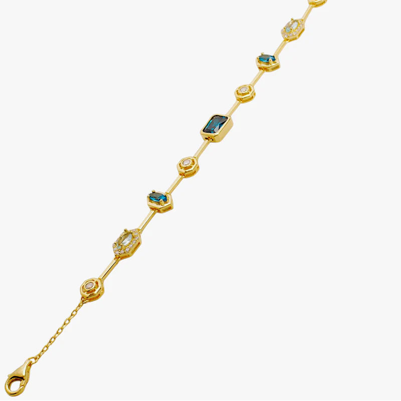 A gold chain bracelet featuring alternating round bezel-set clear stones and rectangular green gemstone 