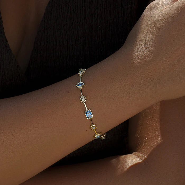 Thin gold toned bracelet with blue stones 38806