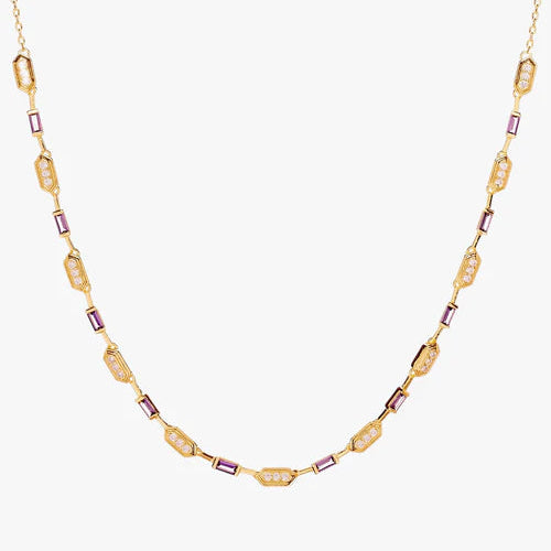 A gold chain necklace featuring alternating textured gold oval links and small rectangular purple crystal accents, displayed against a clean off-white background.