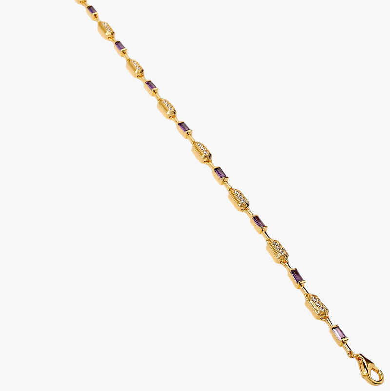 A gold-plated chain bracelet with alternating oval and elongated links, accented by small purple rectangular stones, shown on a plain light gray background.