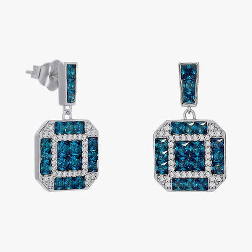 A pair of silver drop earrings featuring rectangular blue gemstone clusters bordered by small clear stones, shown against a light gray background.
