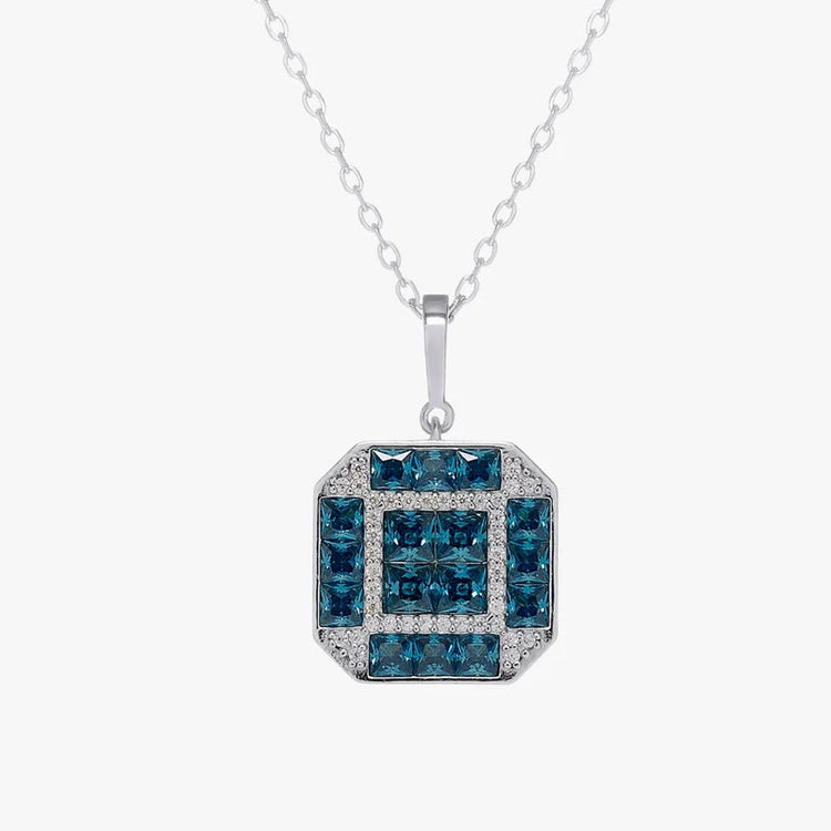 A silver pendant necklace featuring a square geometric design with dark blue gemstones and small clear accent stones, suspended from a delicate silver chain against a light gray background.