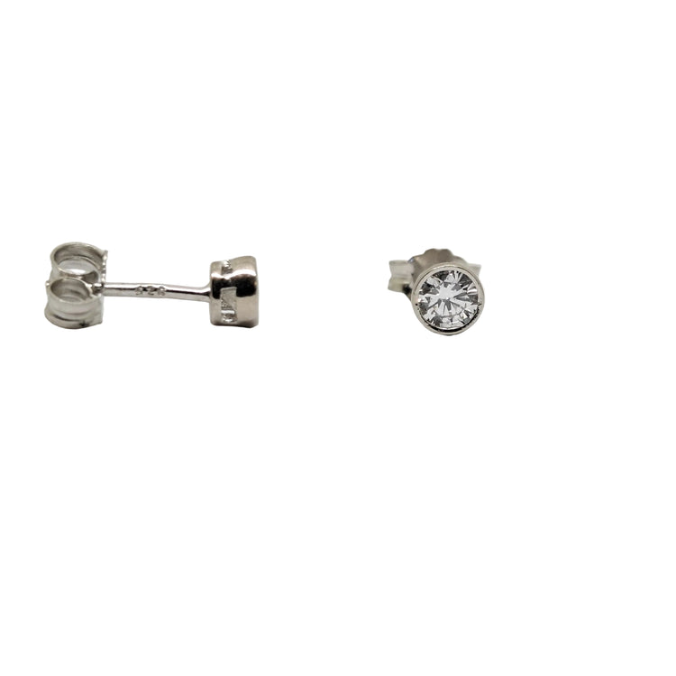 Pair of silver earrings with clear gemstones on a white background