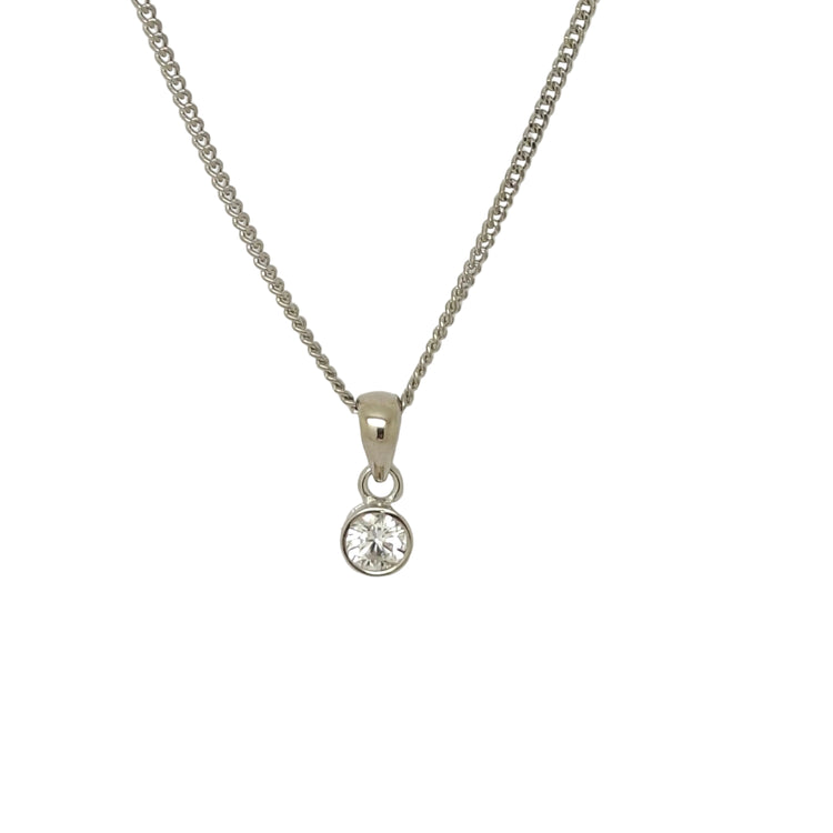 Silver necklace with a round pendant on a light gray background