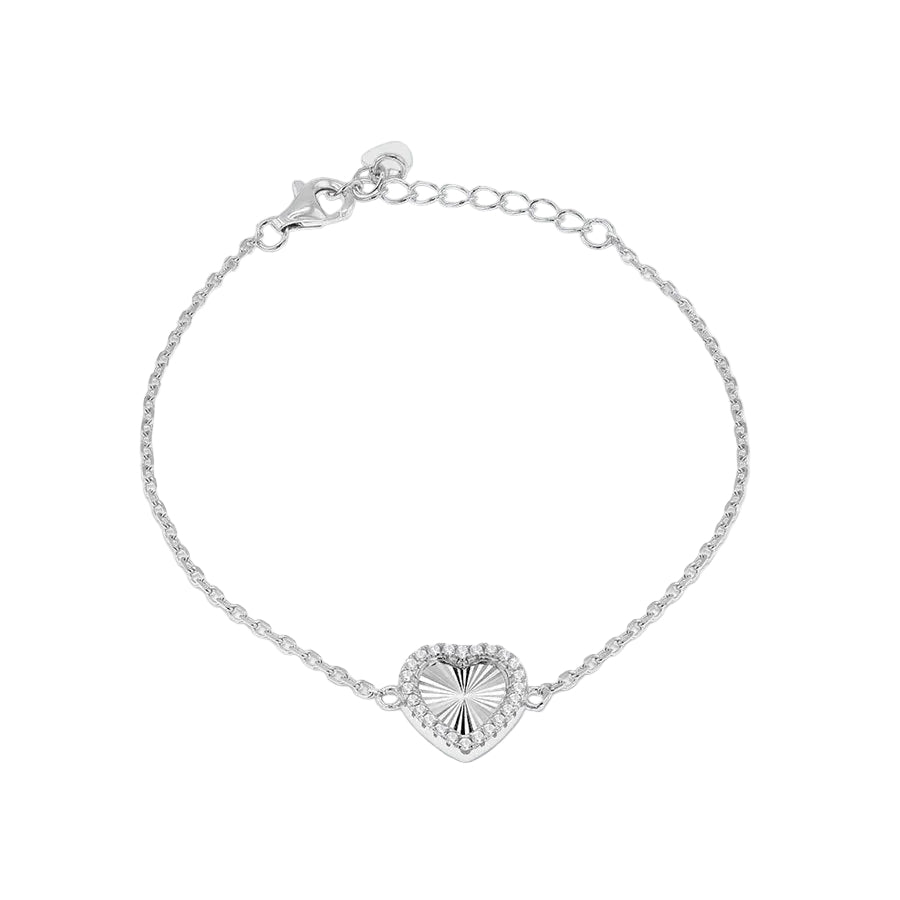 A delicate silver chain bracelet with a heart-shaped pendant featuring a sunburst pattern and a border of small clear stones, set against a soft gray gradient background.