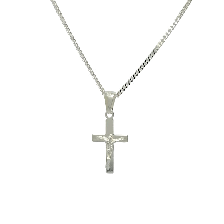 A silver crucifix pendant necklace on a silver chain, displayed against a plain light gray background.