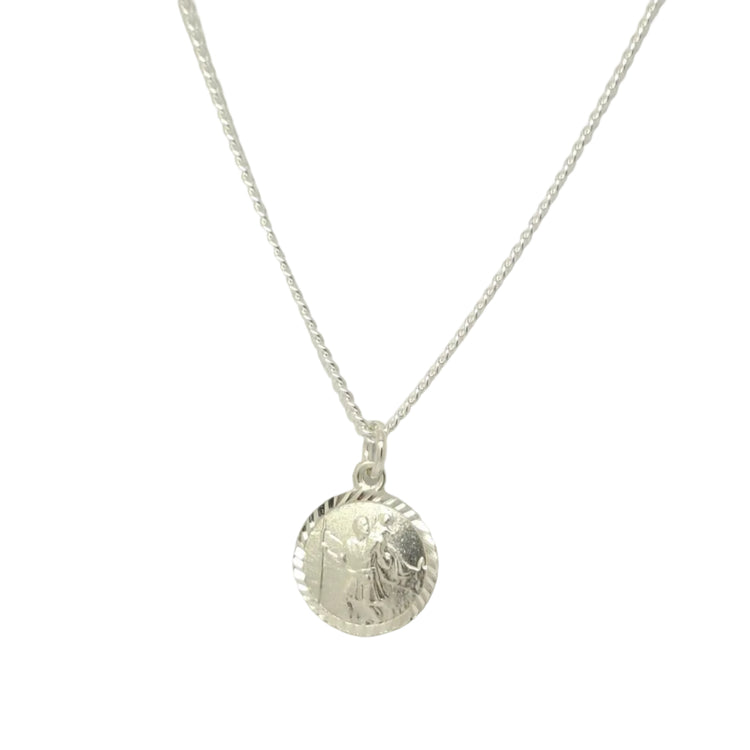 Silver necklace with a round pendant on a light gray background