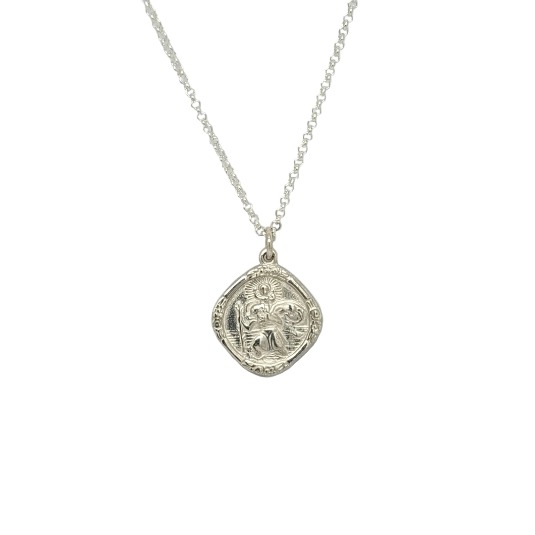 Silver necklace with a detailed pendant on a light gray background