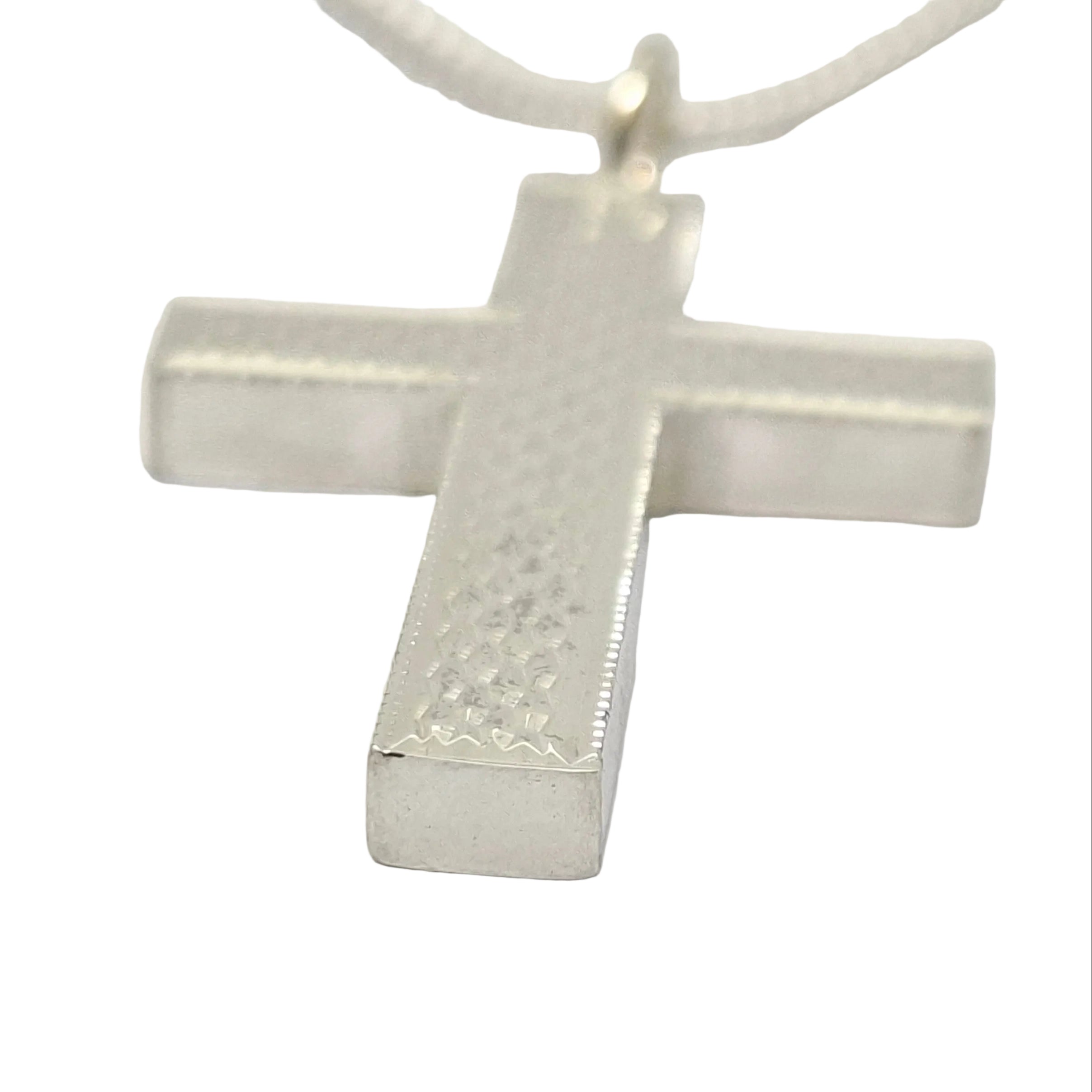 Silver cross pendant on a white background