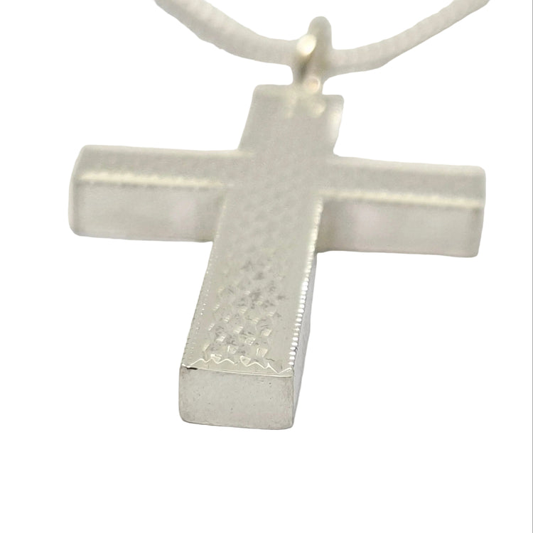 Silver cross pendant on a white background