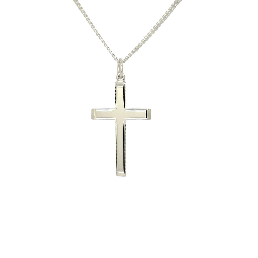 Silver cross necklace on a light gray background