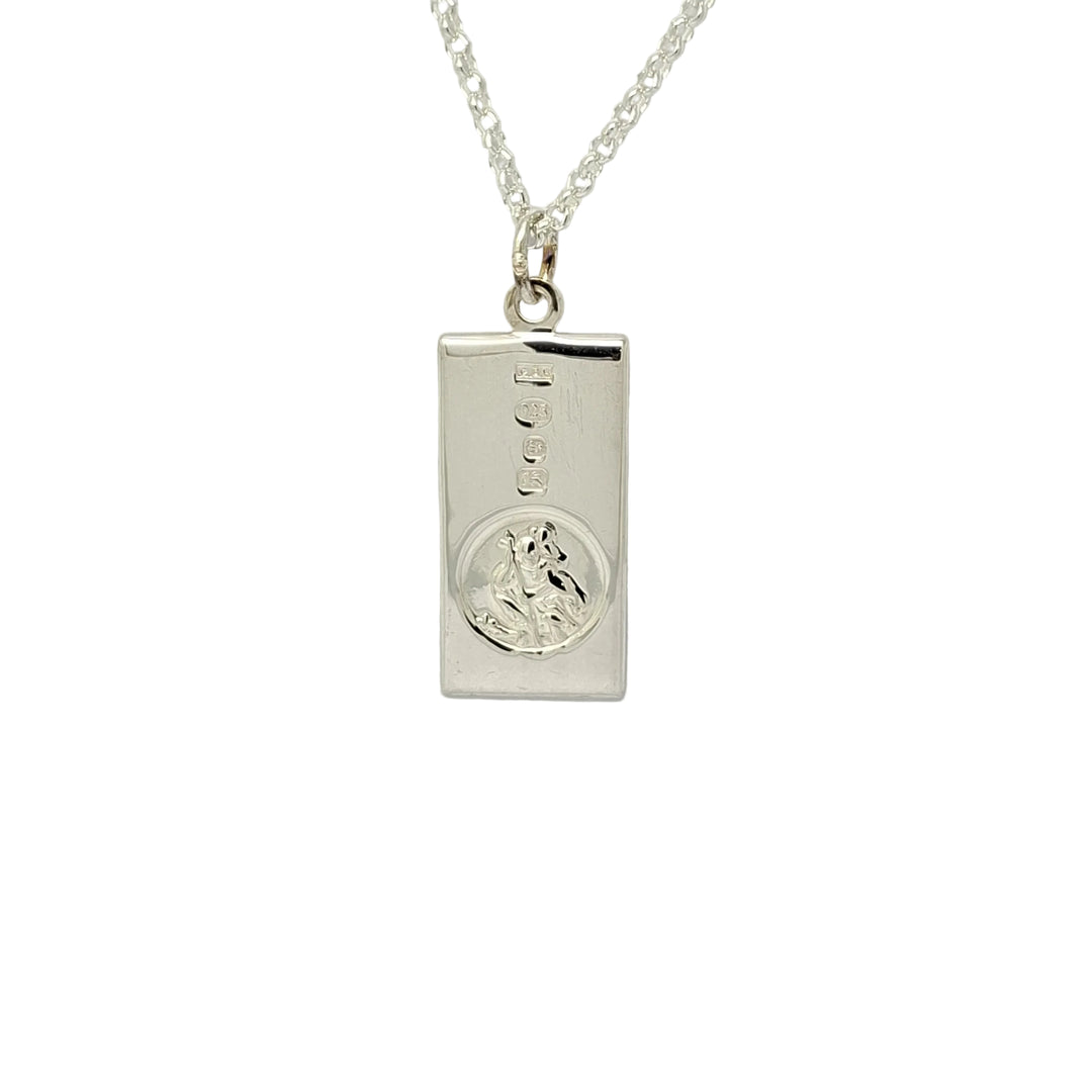 Silver necklace with a rectangular pendant on a light gray background
