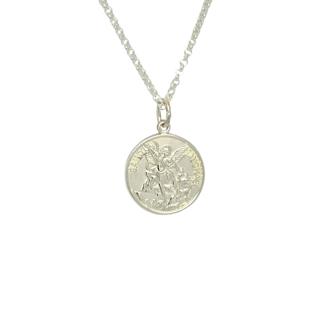 Silver Sr. Michael necklace with a chain on a light gray background