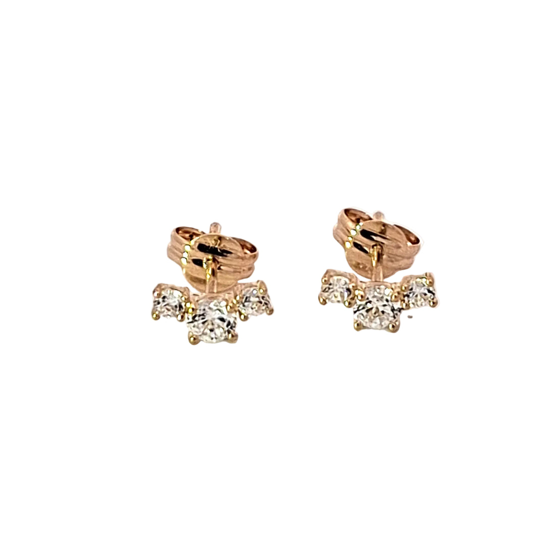 Pair of gold earrings with clear gemstones on a white background