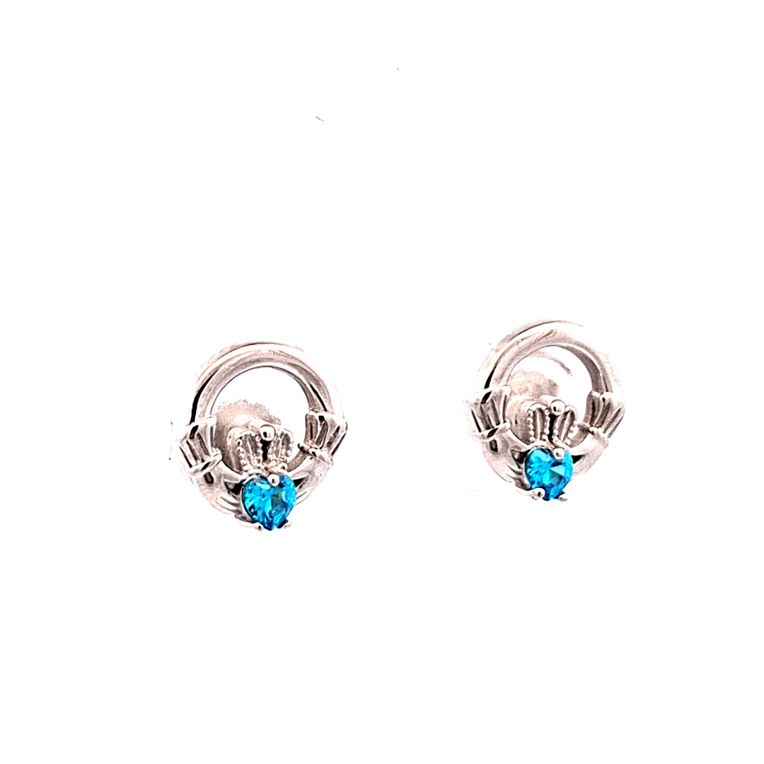 Pair of silver claddagh earrings with blue gemstones on a white background