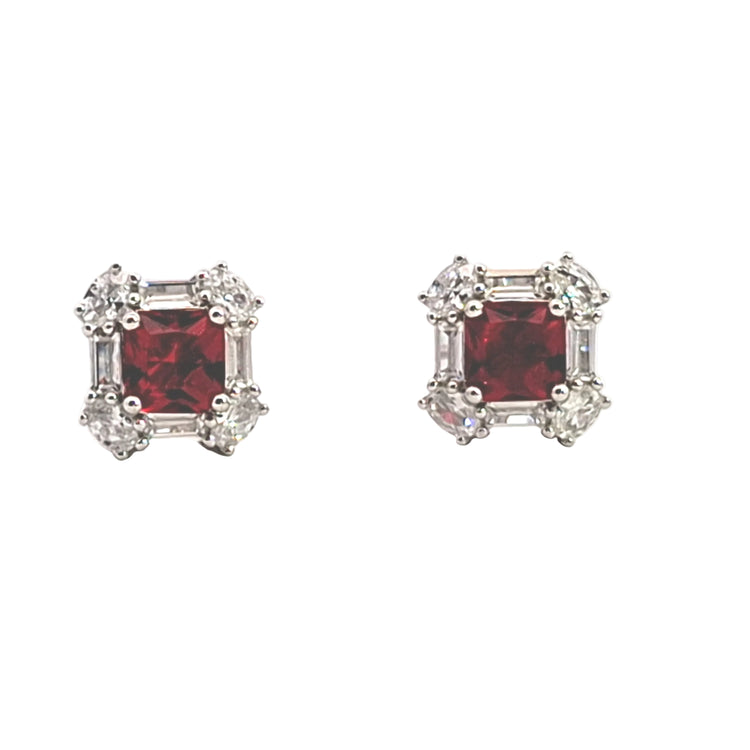 Pair of red gemstone earrings with silver accents on a white background