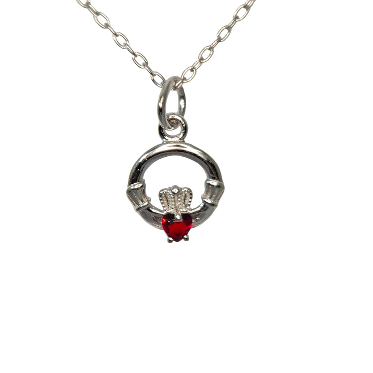 Silver claddagh pendant with a red gemstone on a white background