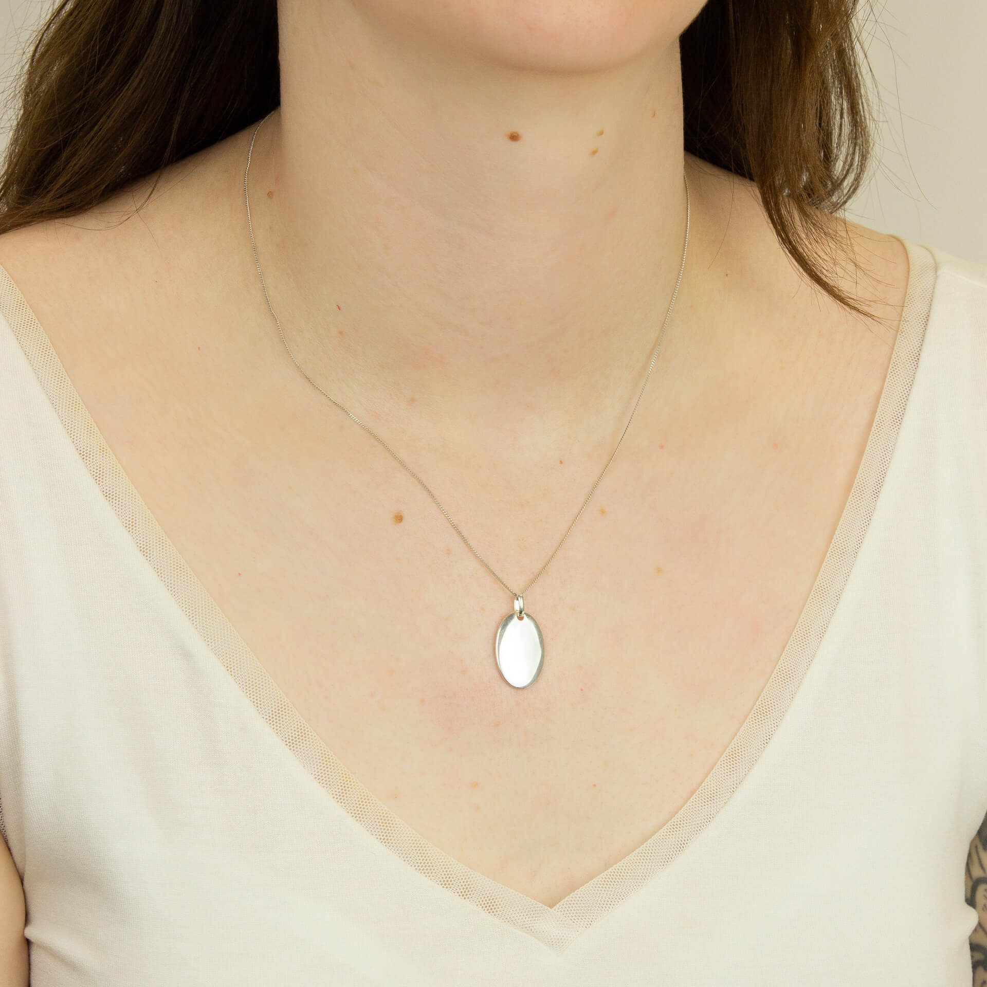 Sterling silver 14mm x 22mm oval disc, ready for engraving. Select chain. 35717 - Armin Lowe Jewellers